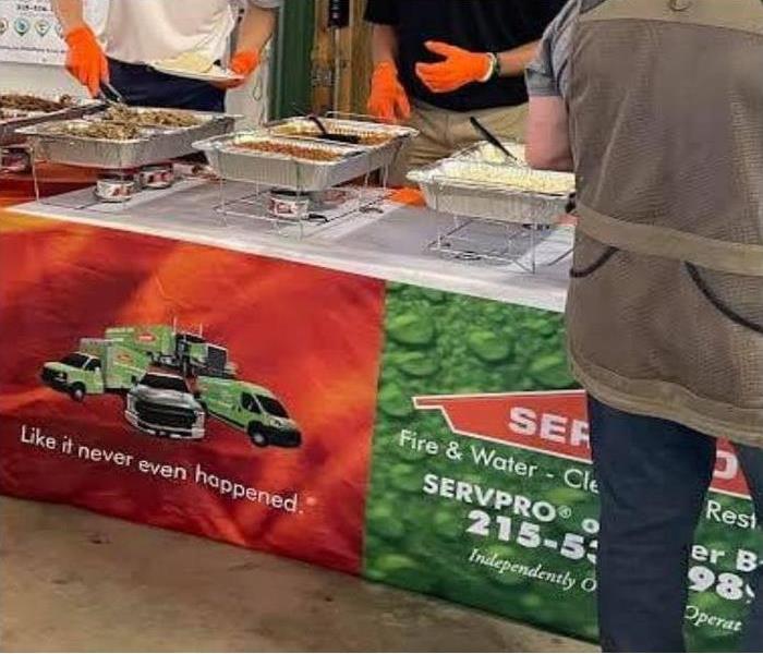 a close up photo of a serving table with trays of food