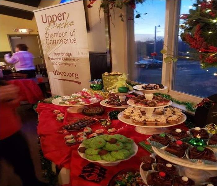 A table full of deserts in front of a window